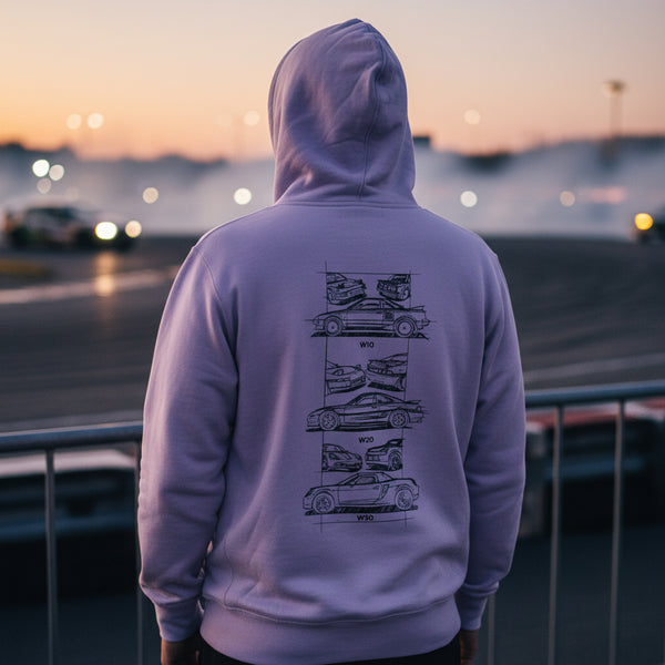 Back of a lavender Toyota MR2 Heritage hoodie worn at dusk beside a track, MR2 line drawings visible